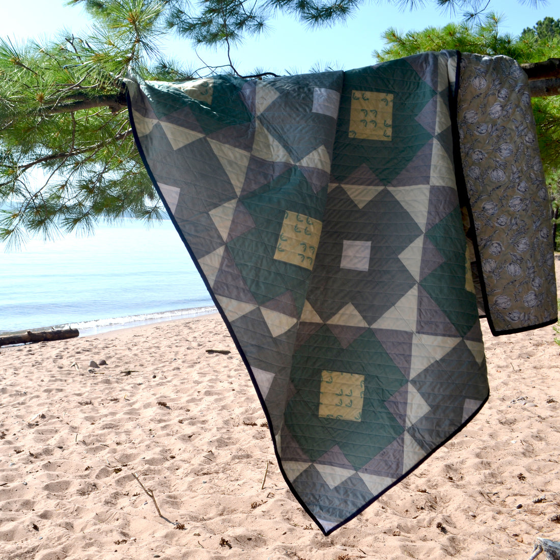 The blue and white county quilt on the beach of Lake Superior.