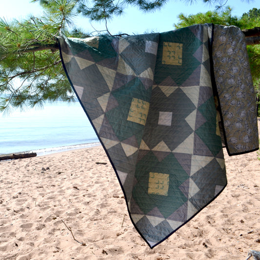 The blue and white county quilt on the beach of Lake Superior.