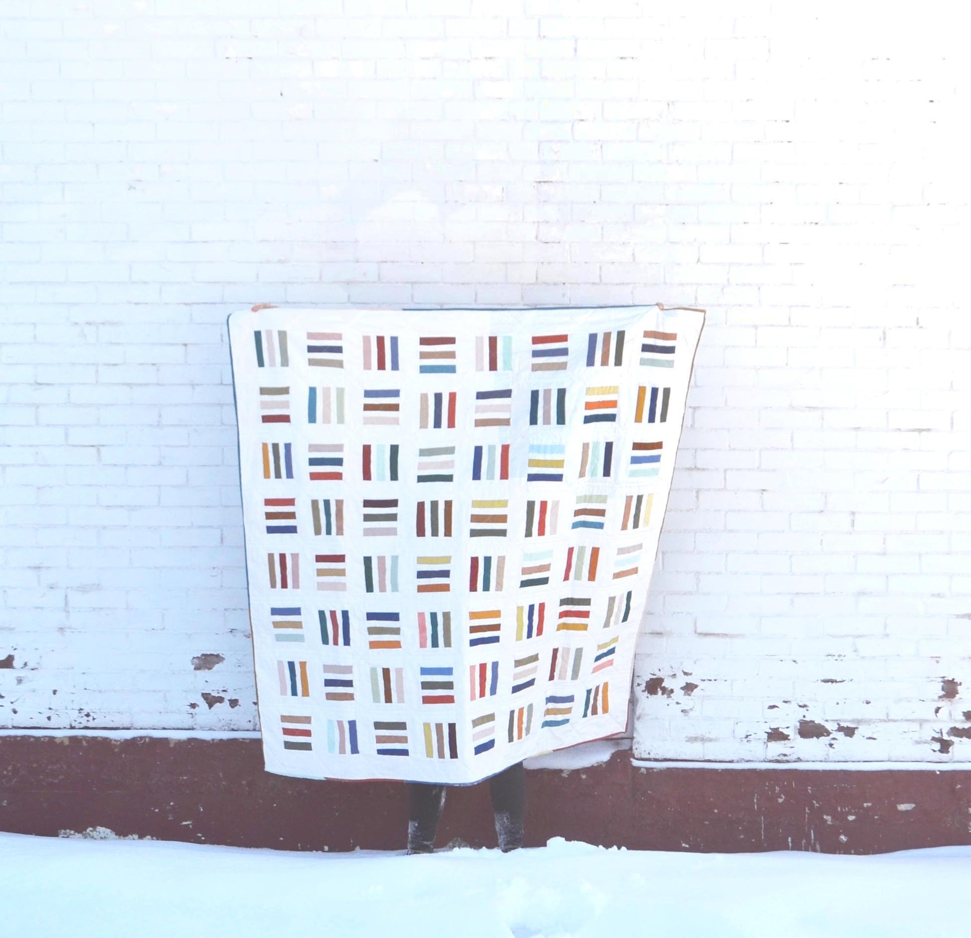 A modern quilt pattern using scrap fabrics or small lines